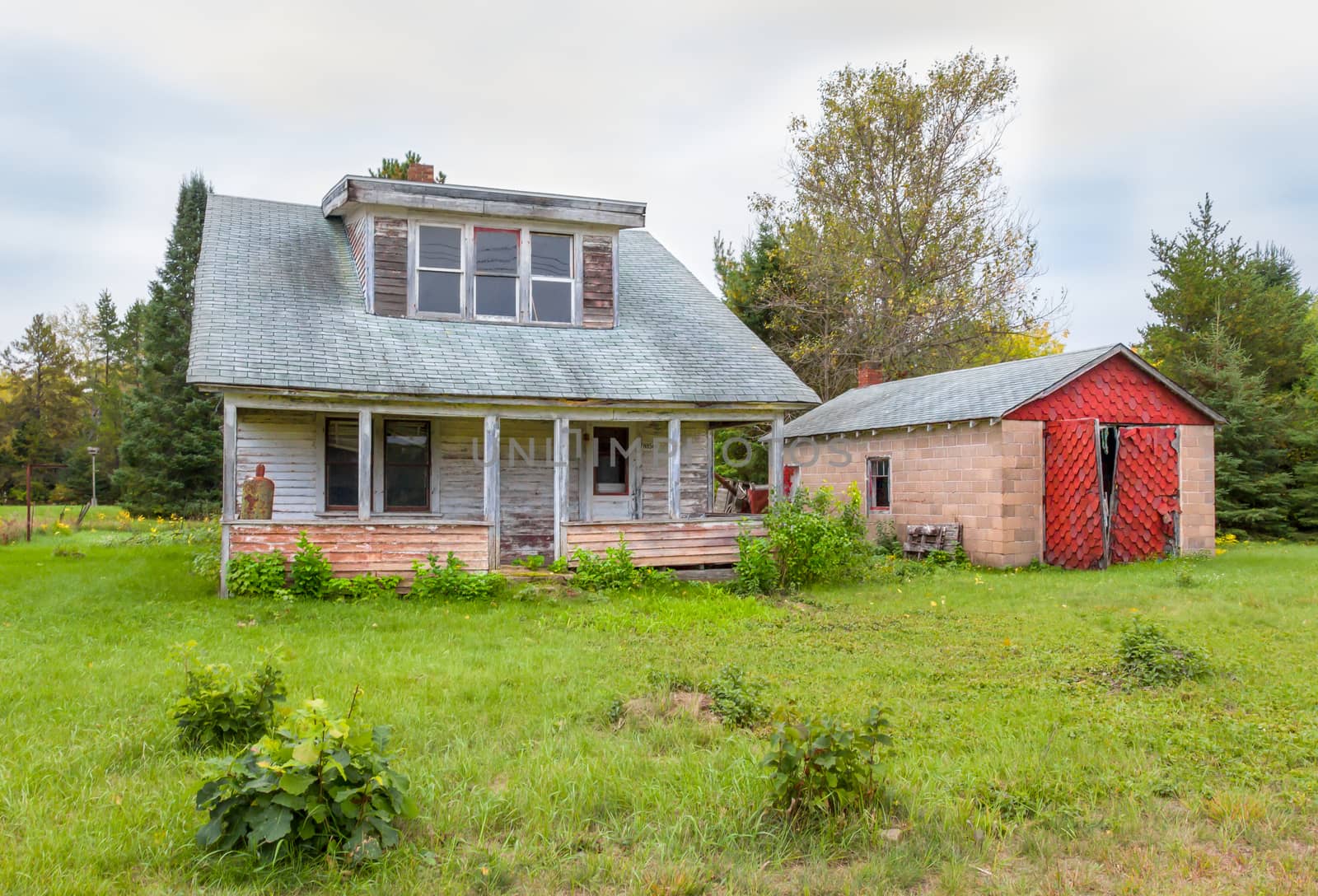 Abandoned farm house and garage in rural United States.