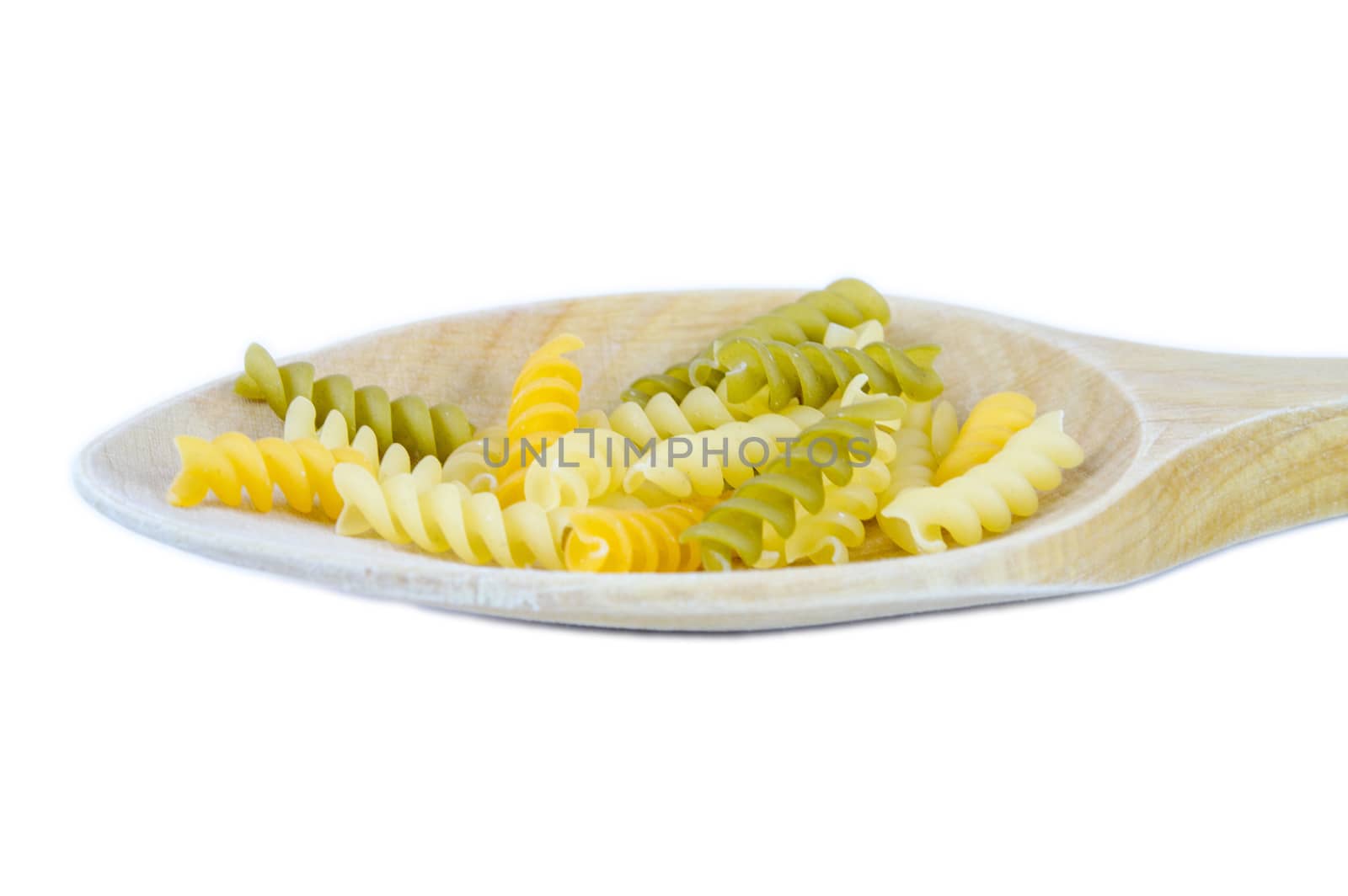 Raw macaroni on a spoon isolated