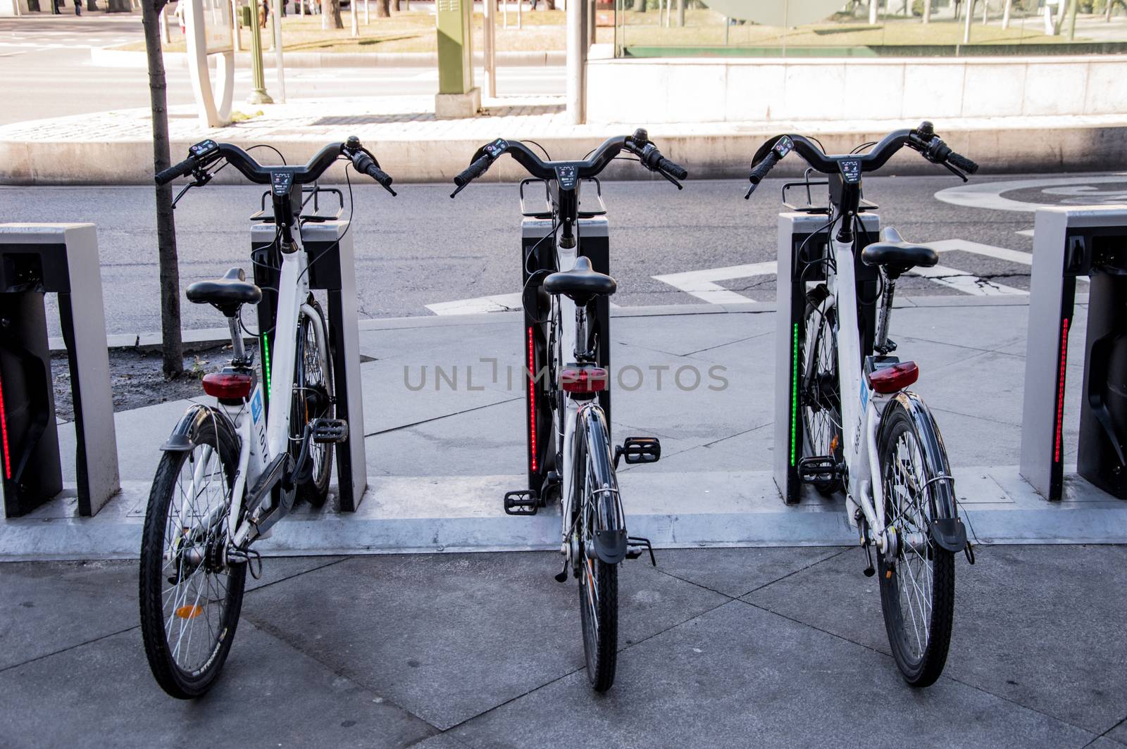 Three urban rental bikes parked