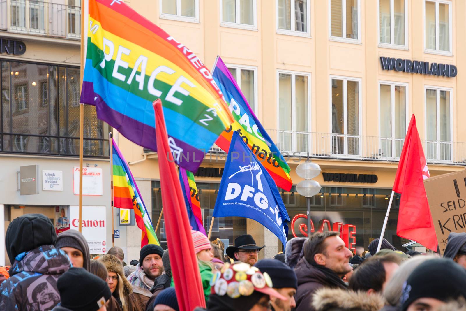 Munich, Germany - February 7, 2015: European peaceful march with flags, placards and banners on central street