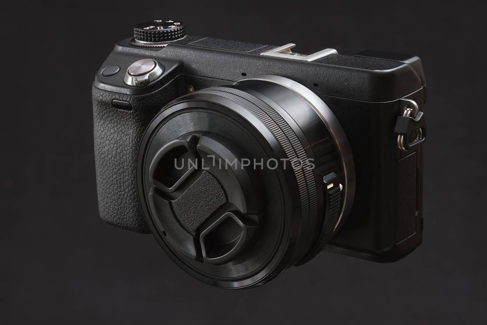 black mirrorless camera on a black background