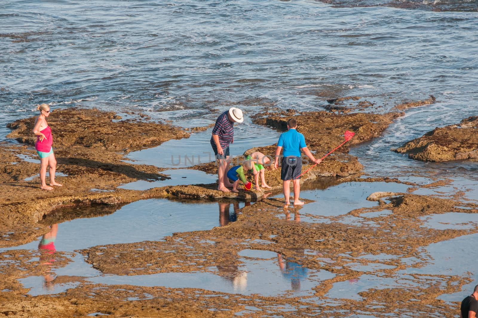 MOSSELBAY, SOUTH AFRICA - JANUARY 1, 2015: Unidentified people late afternoon at the Reebok beach