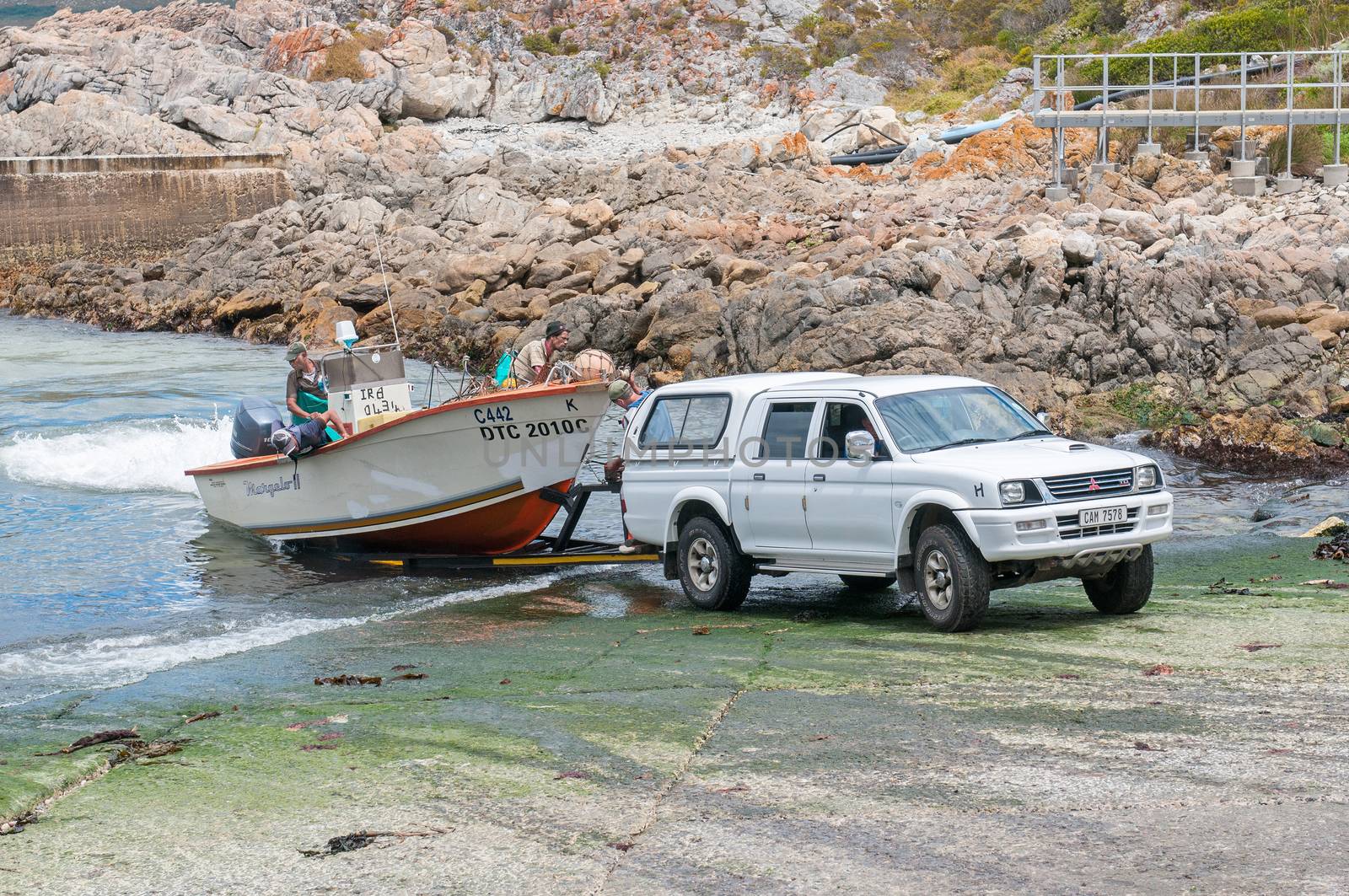 KLEINMOND, SOUTH AFRICA - DECEMBER 23, 2014: Crayfish boat being pulled onto a trailer with the days catch at Kleinmond harbor