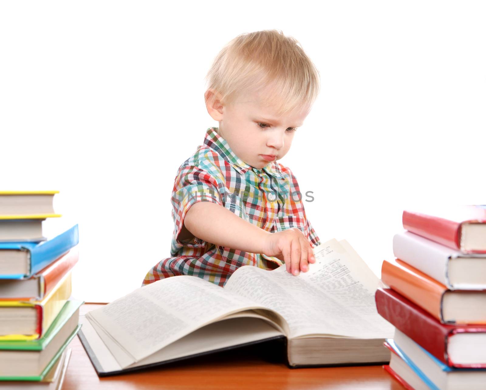 Little Child open the Book at the Desk Isolated on the White Background