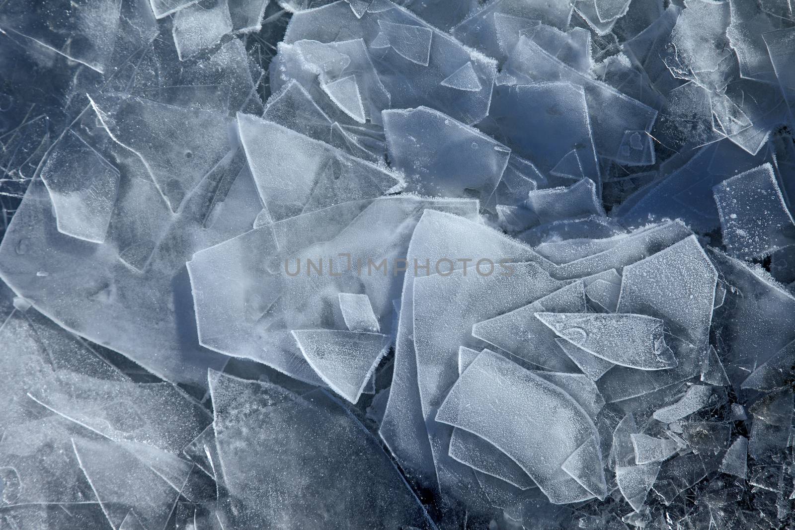 Cracked blue ice on frozen water