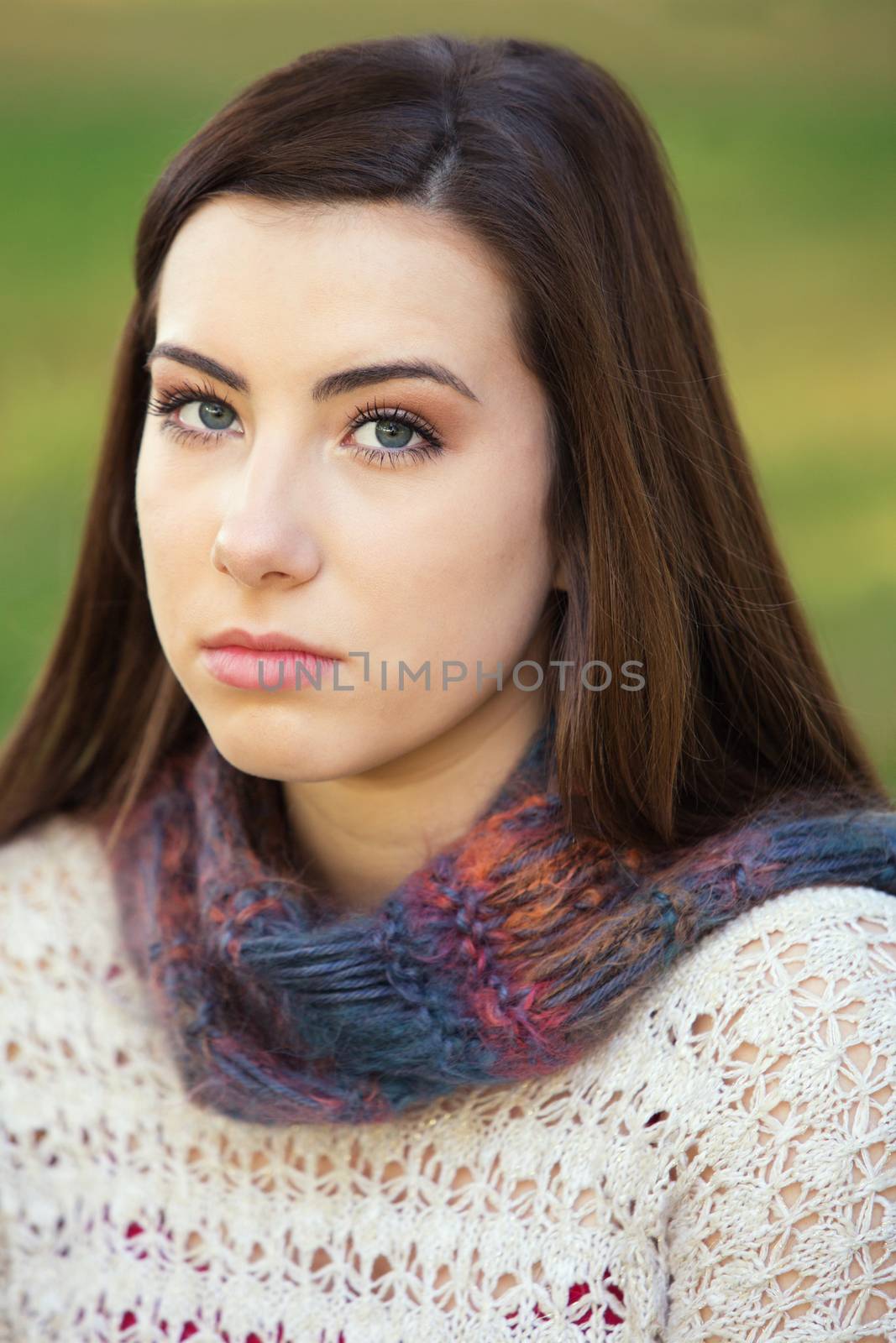 Single serious female teenager in sweater staring