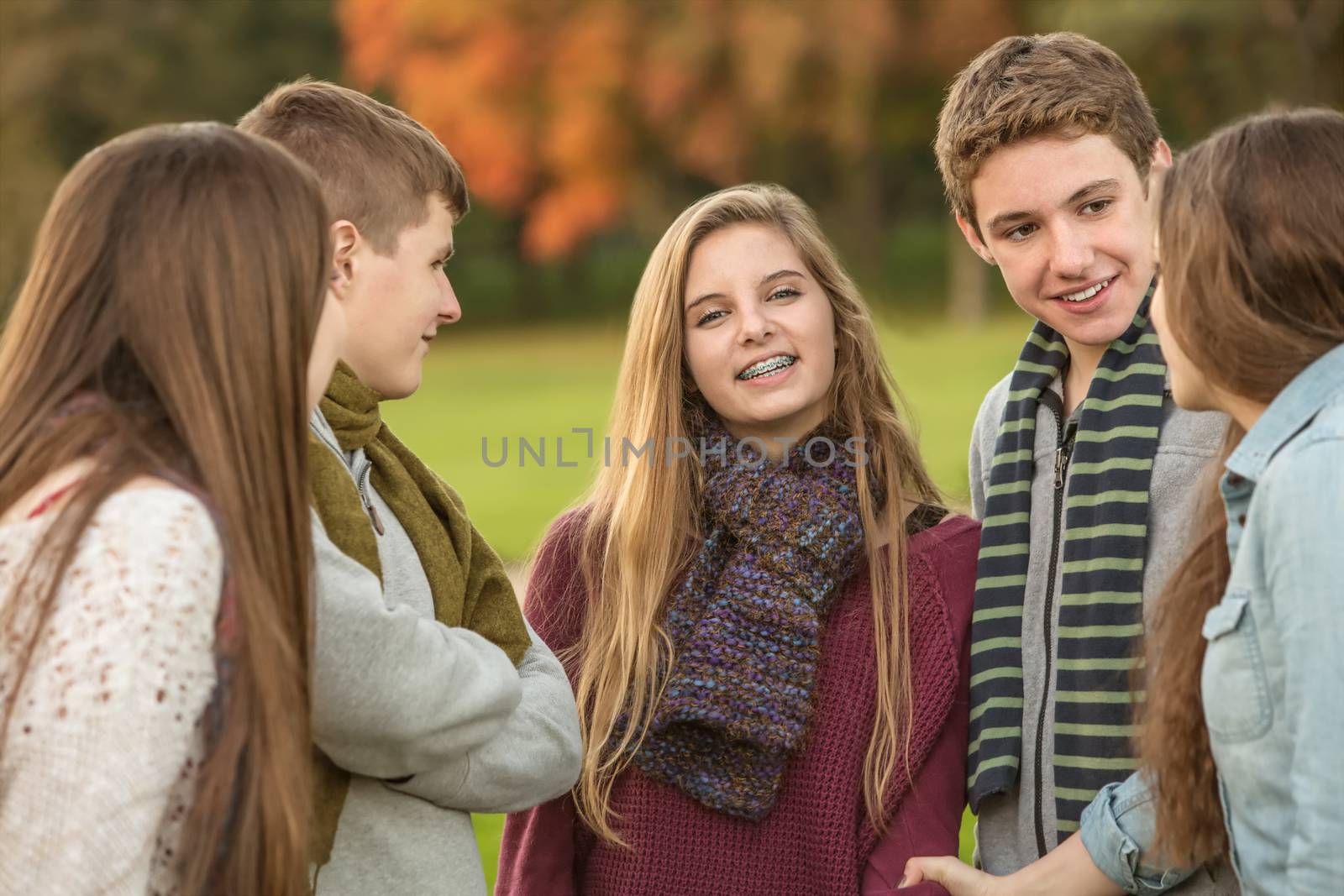 Smiling Caucasian teen female with group of friends