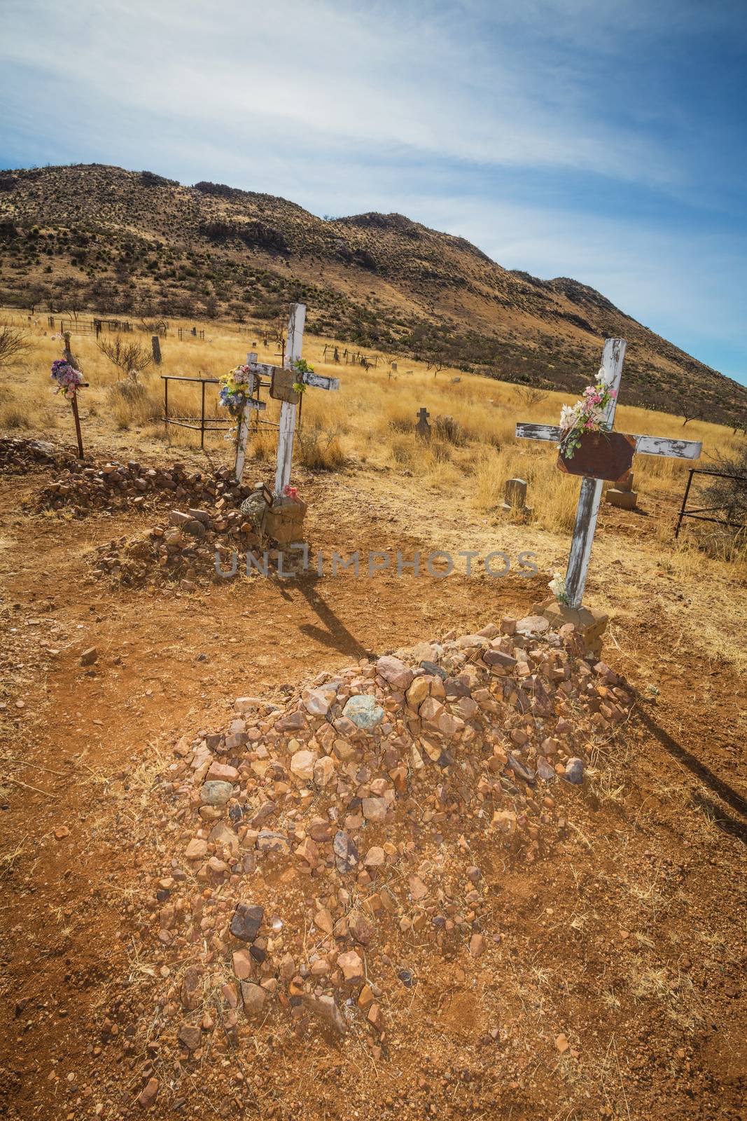 Three old stone graves in Arizona desert