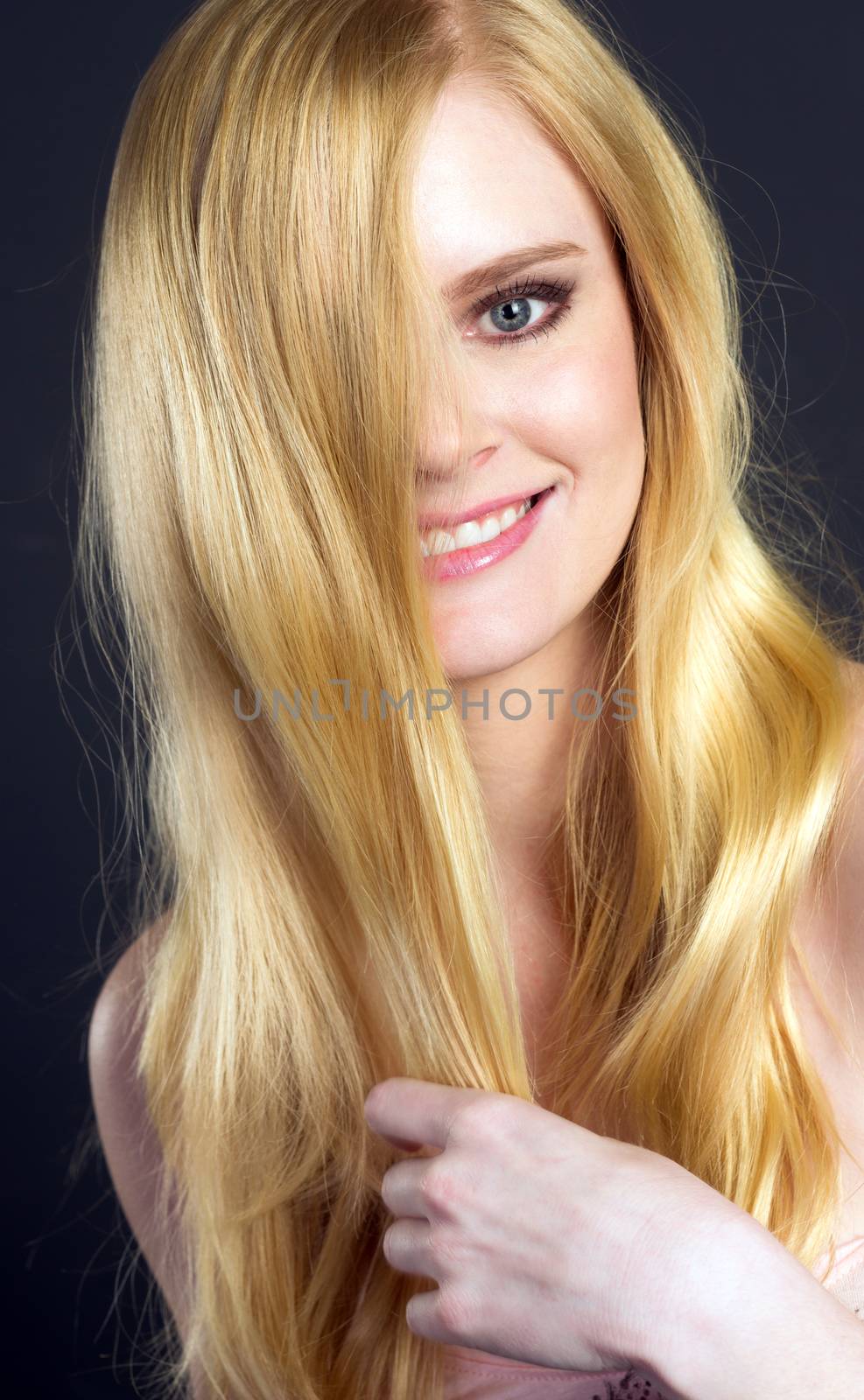 Beautiful Smiling Blond Woman Grooming Brushing Her Hair by ChrisBoswell