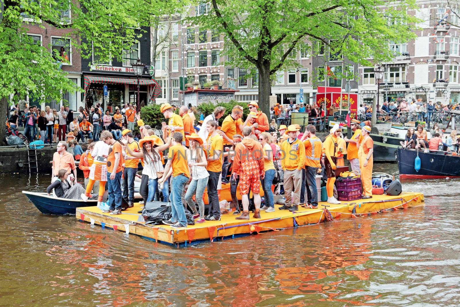AMSTERDAM - APRIL 26: Canals of Amsterdam full of people in orange on boats during the celebration of kings day on April 26, 2014 in Amsterdam, The Netherlands