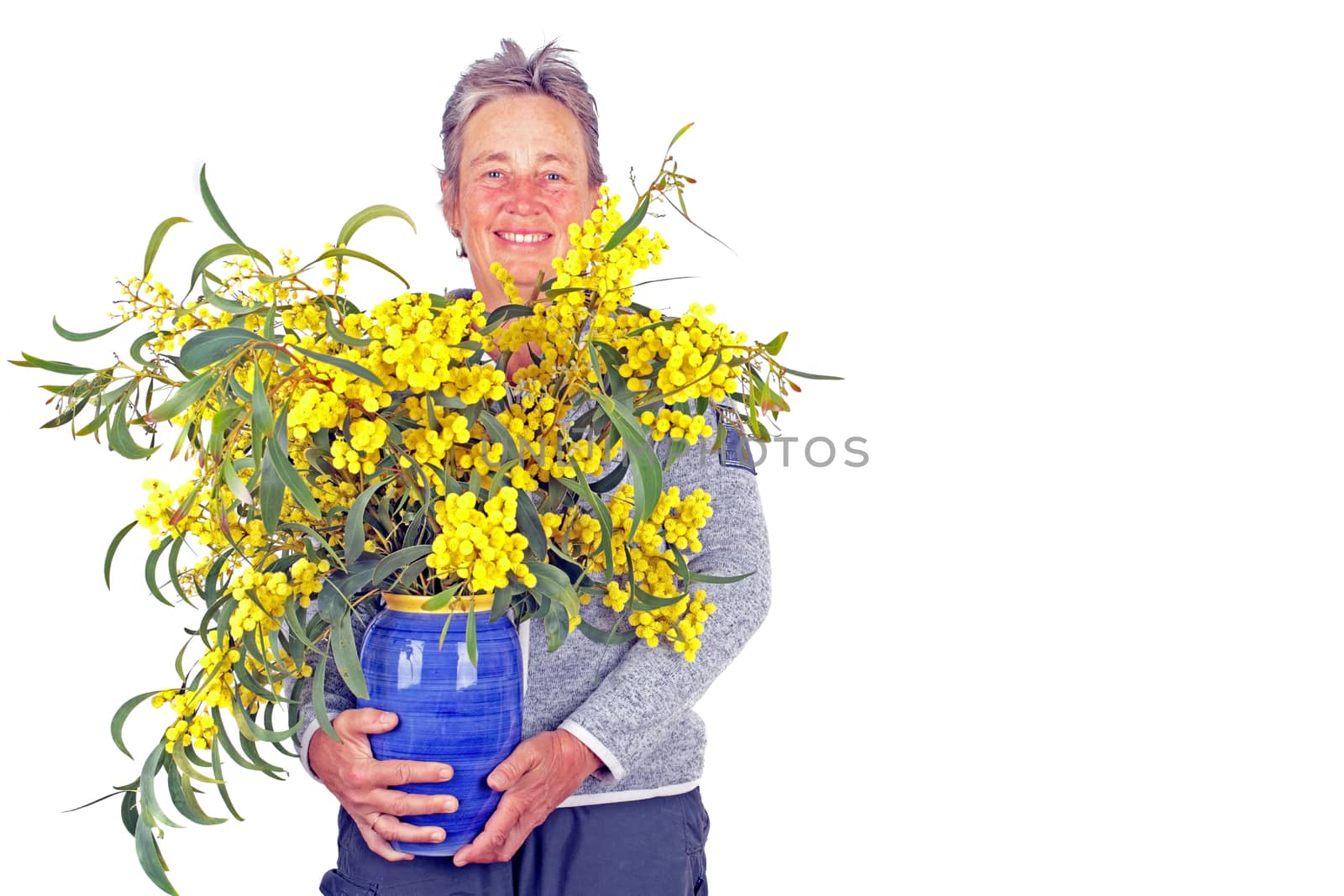  Beautiful mature woman with a bouquet of mimosa
