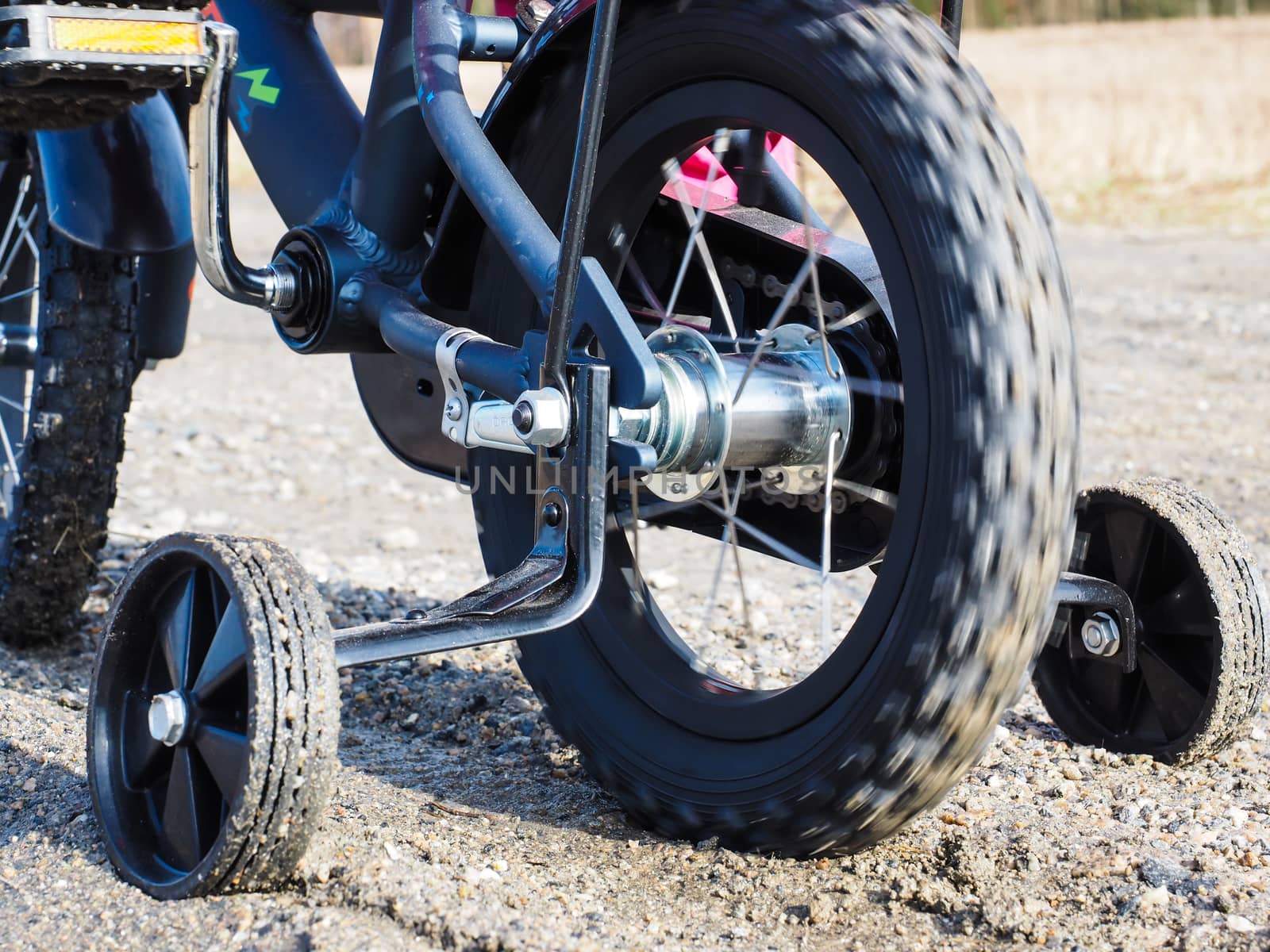 Bicycle with supporting wheels stuck in loose gravel