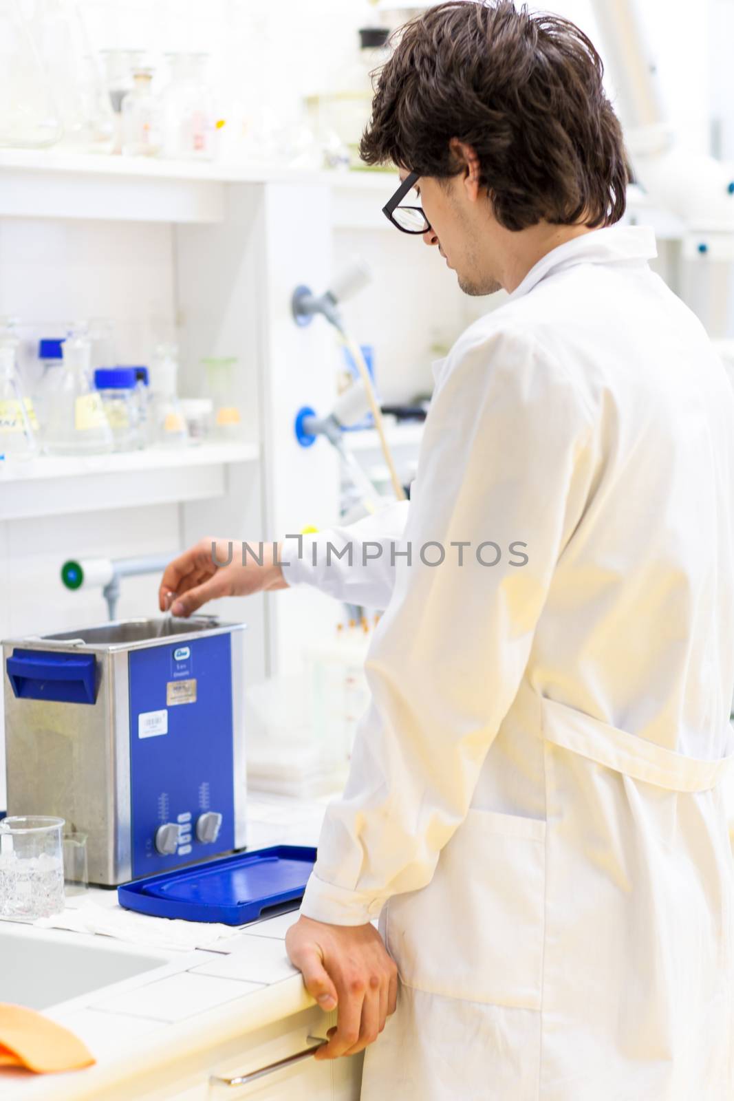 Male researcher carrying out scientific research in a lab (shallow DOF; color toned image)