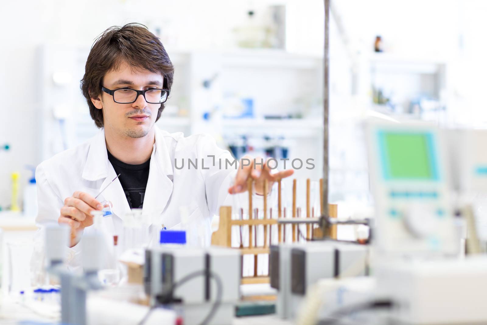 Male researcher carrying out scientific research in a lab (shallow DOF; color toned image)
