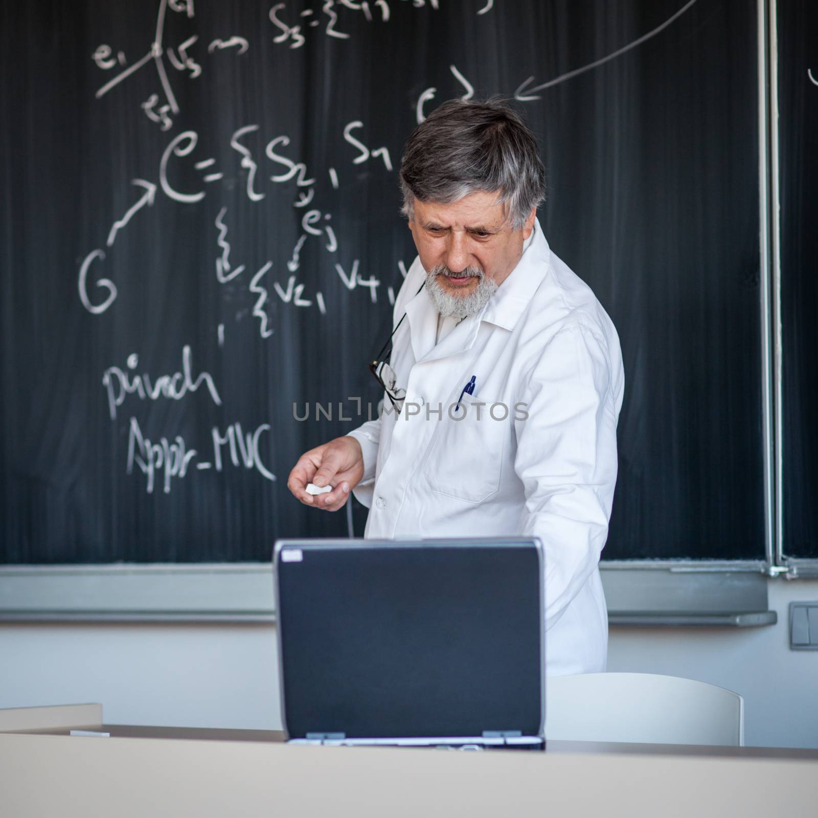 Senior chemistry professor writing on the board by viktor_cap