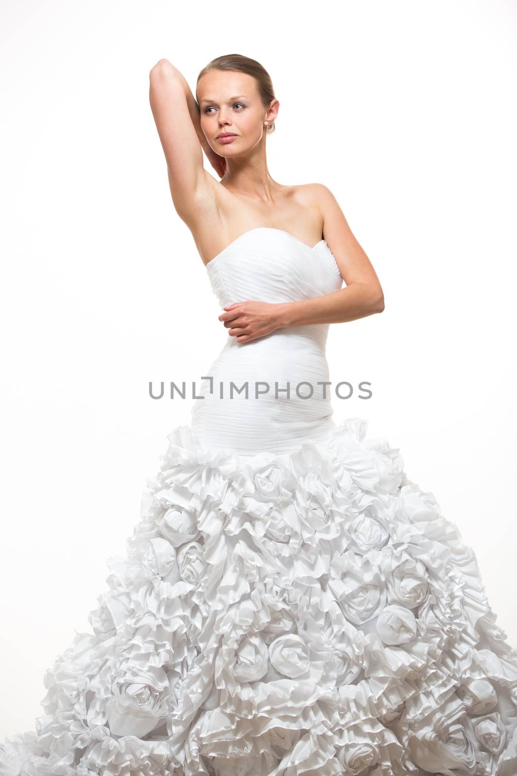 Gorgeous bride in her wedding dress on white background