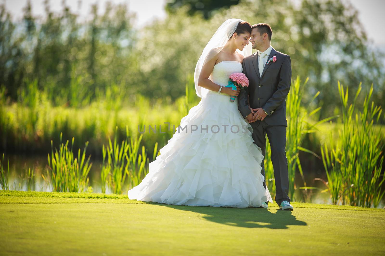 Portrait of a young wedding couple on their wedding day by viktor_cap