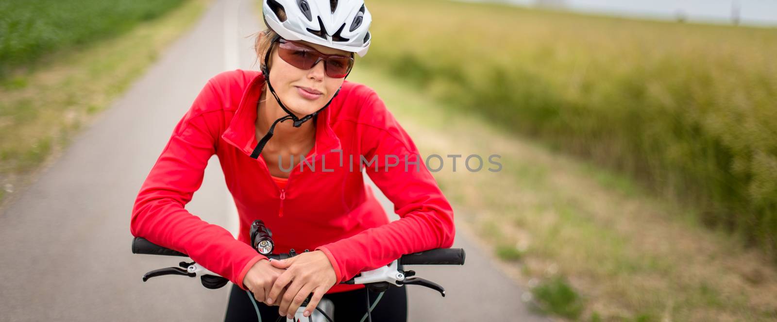 Pretty, young female biker outdoors by viktor_cap