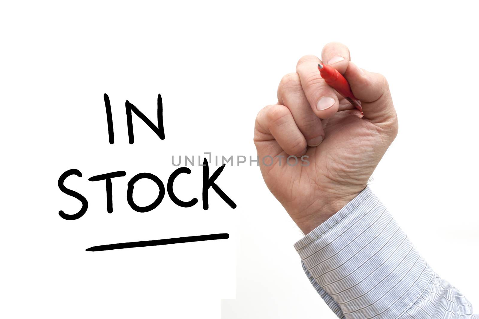 A Photo / Illustration of a Hand Writing 'In Stock'