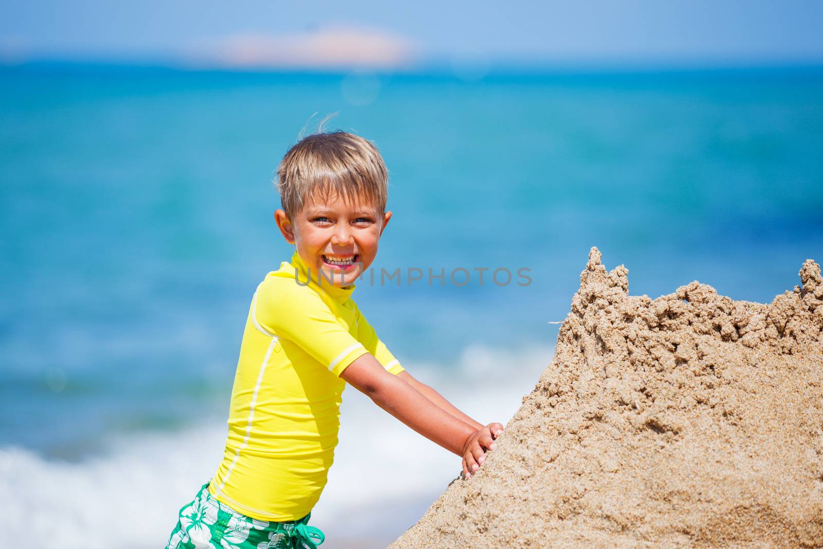 Young boy playing in the sand on the beach