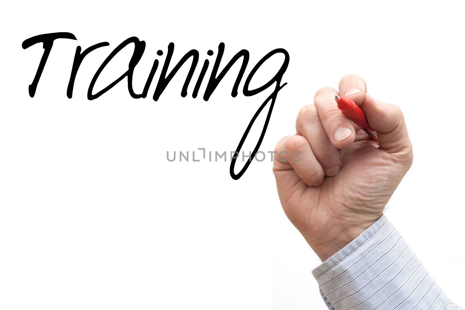 A Photo / Illustration of a Hand Writing 'Training'