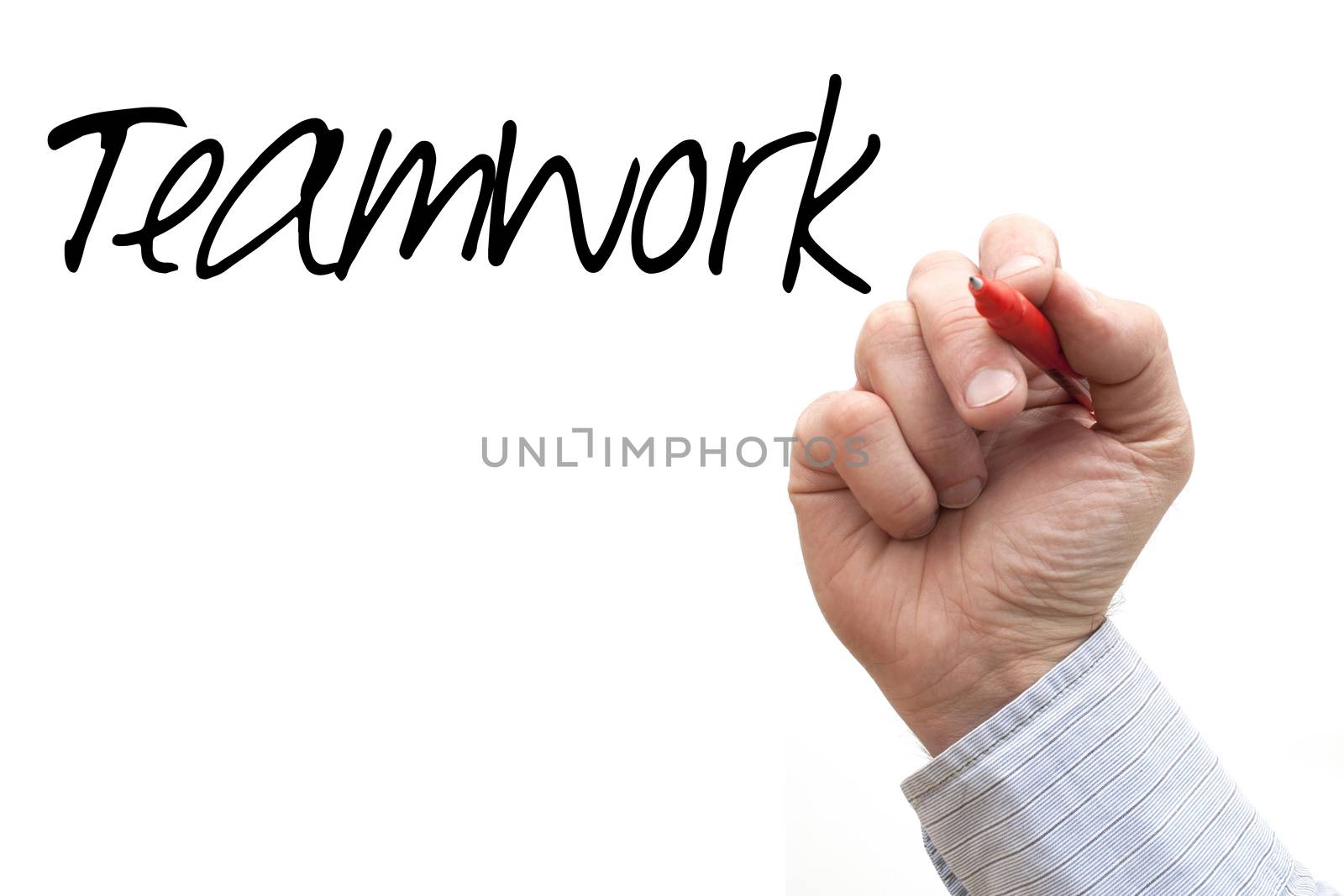 A Photo / Illustration of a Hand Writing 'Teamwork'