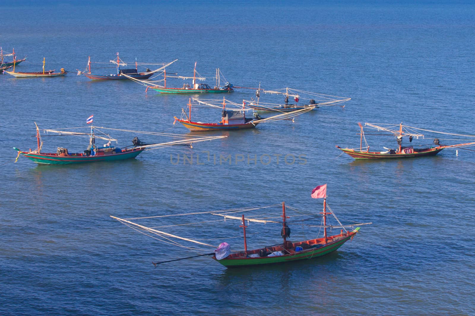 The fishing boat anchored at the beach.