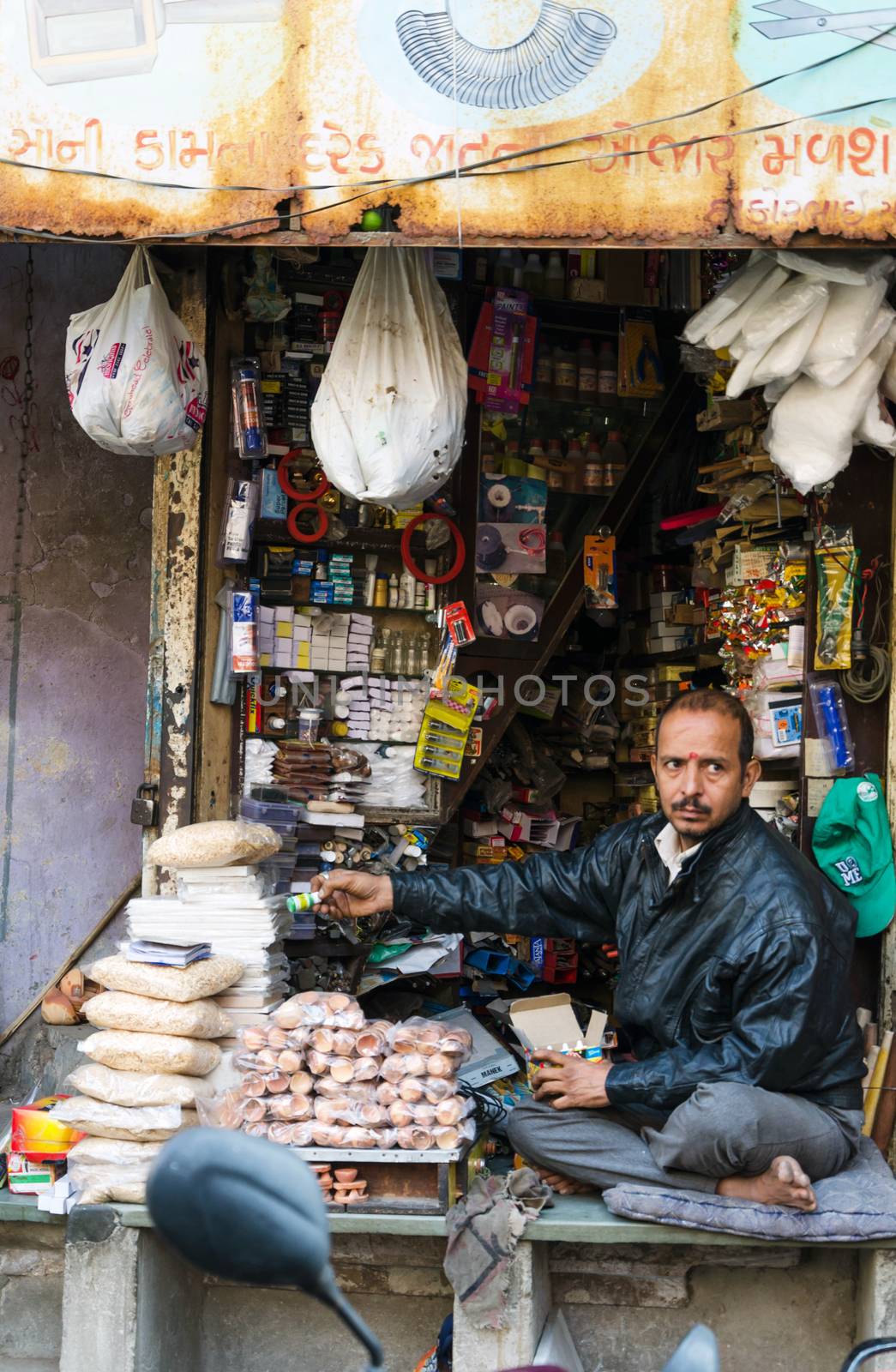Ahmedabad, India - December 28, 2014: Unidentified Indian man selling variety product at market in Ahmedabad by siraanamwong