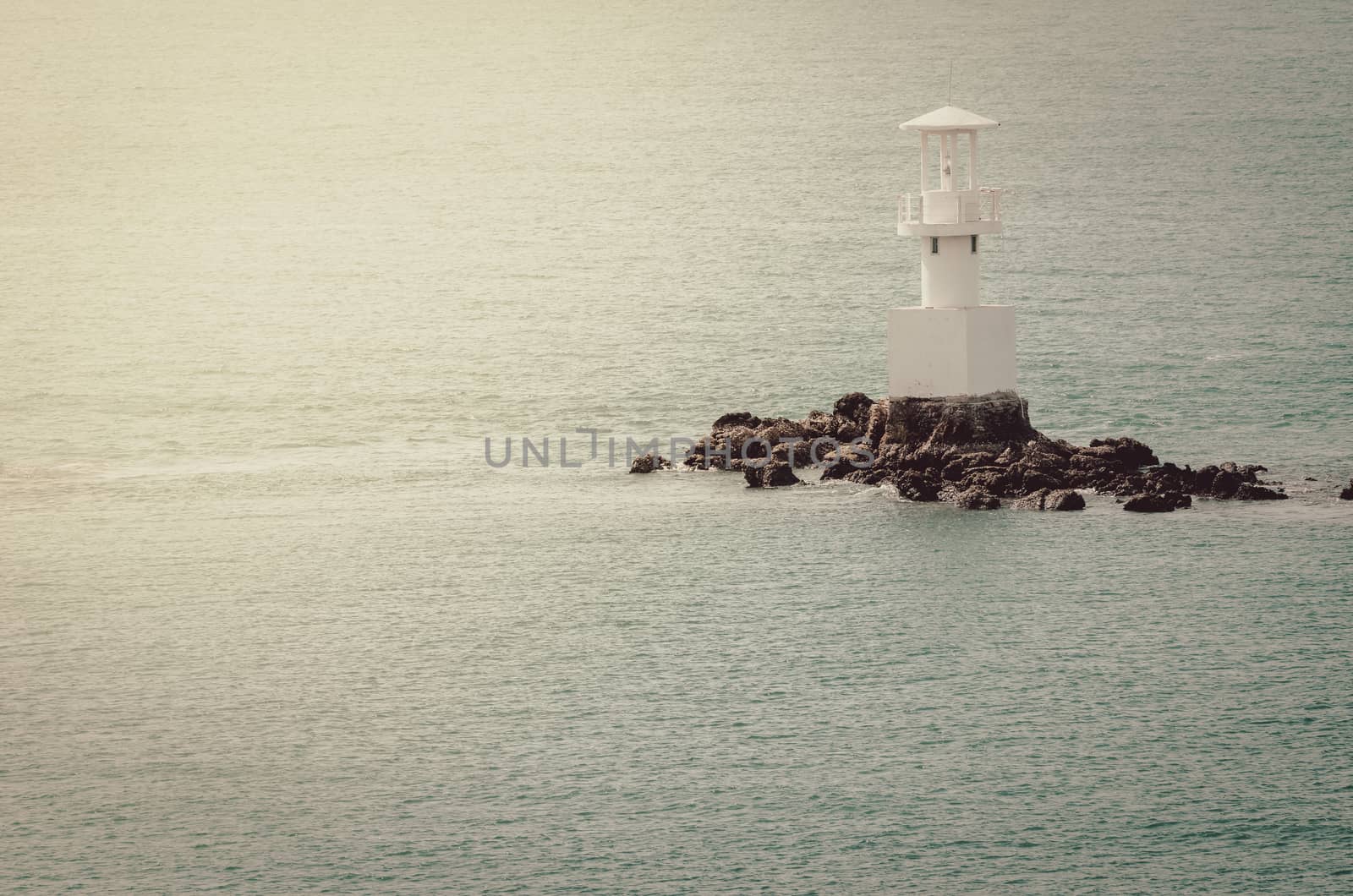 White Lighthouse on the sea and blue sky in Thailand vintage