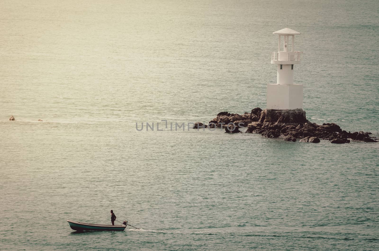 White Lighthouse on the sea and blue sky in Thailand vintage