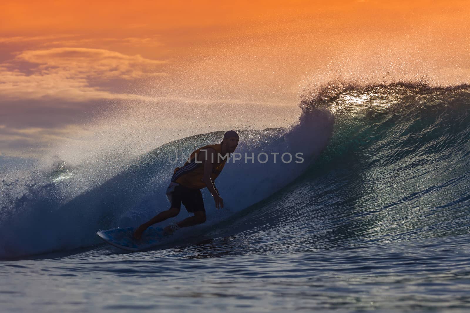 Surfer on Amazing Wave at sunset time, Bali island.