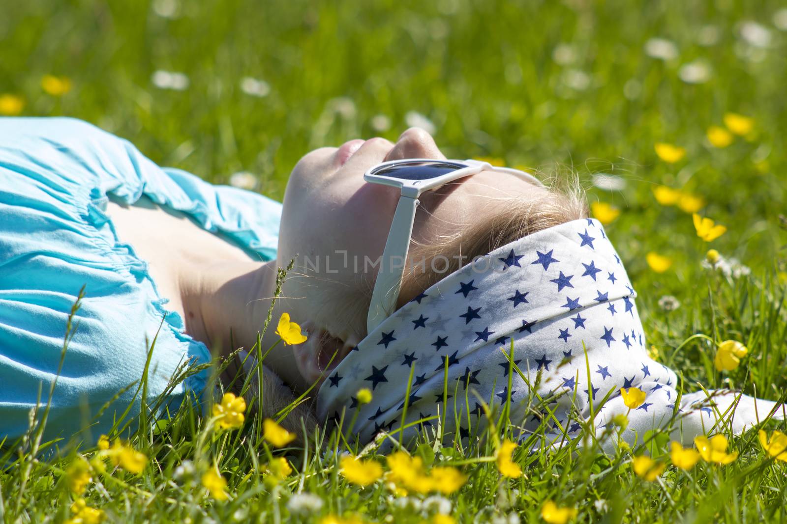 little girl lying on grass