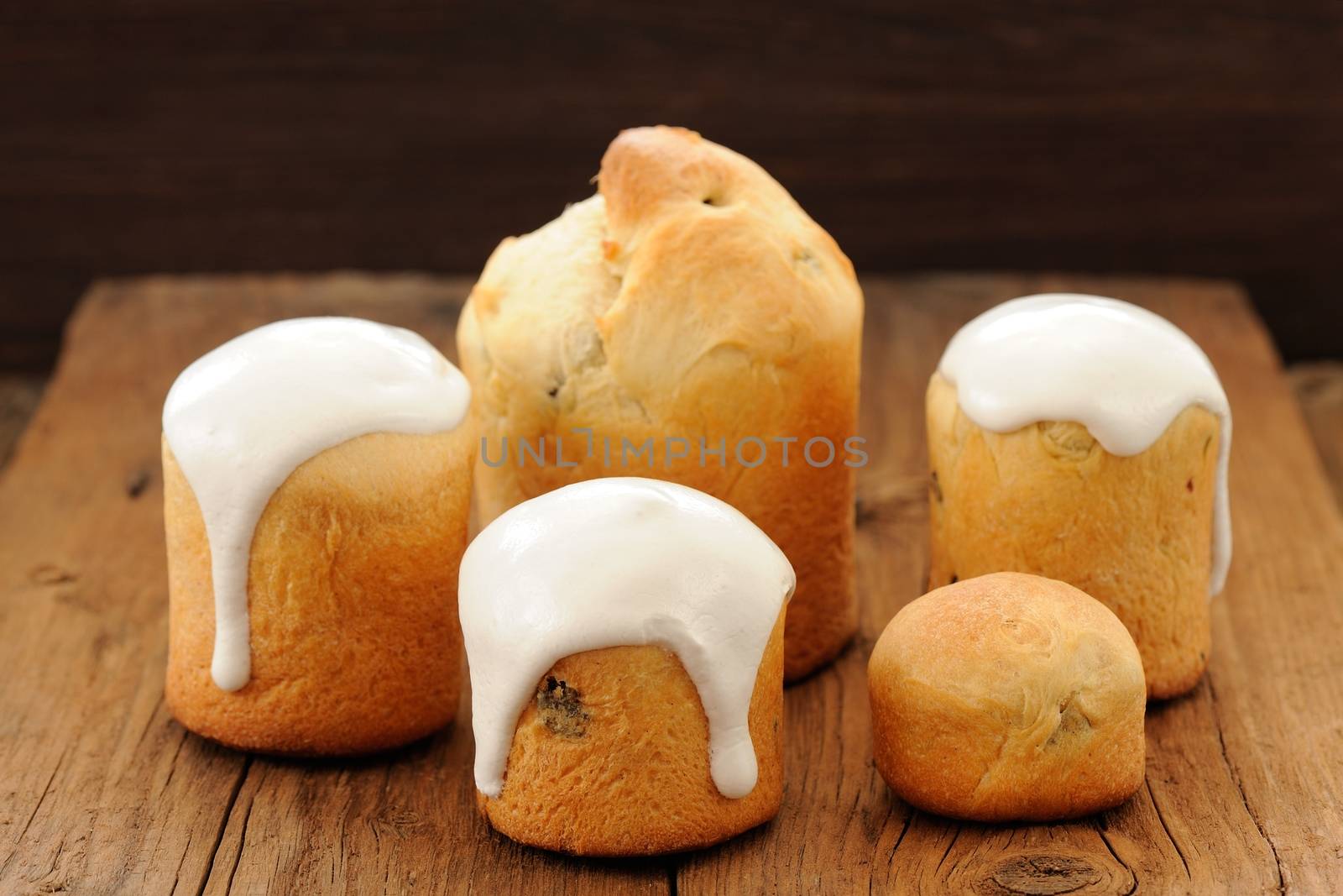 Kulichi, traditional Russian Easter cake with icing on wooden background horizontal
