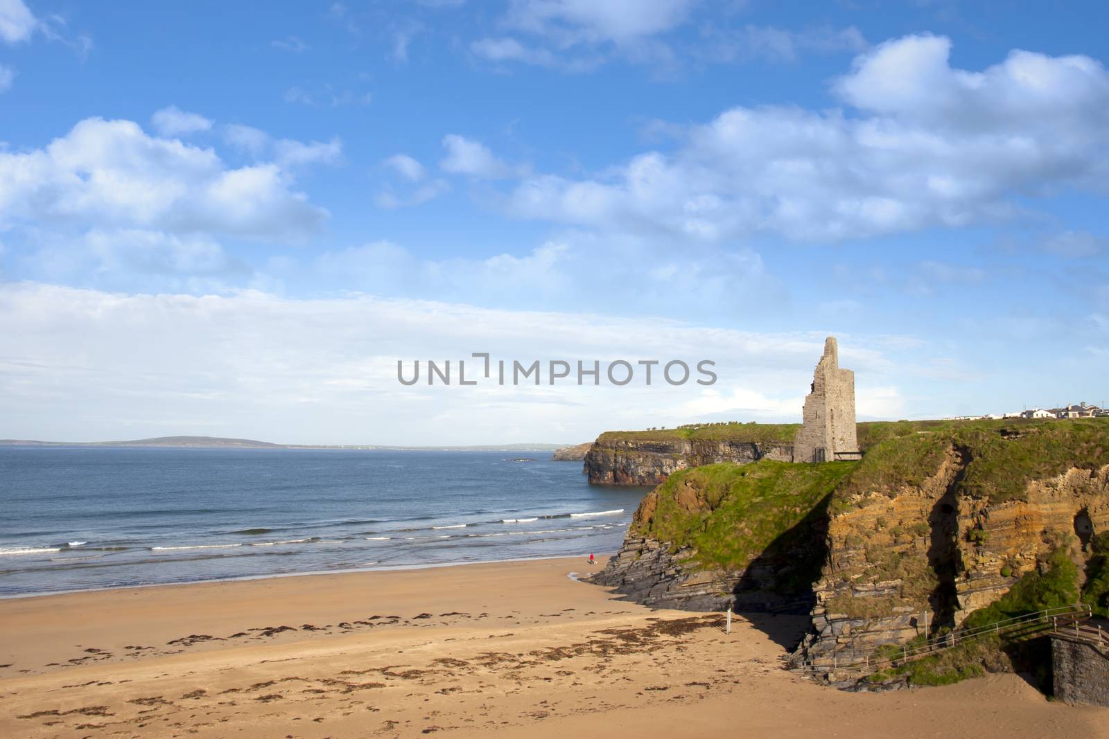 view of the Ballybunion beach castle and cliffs by morrbyte