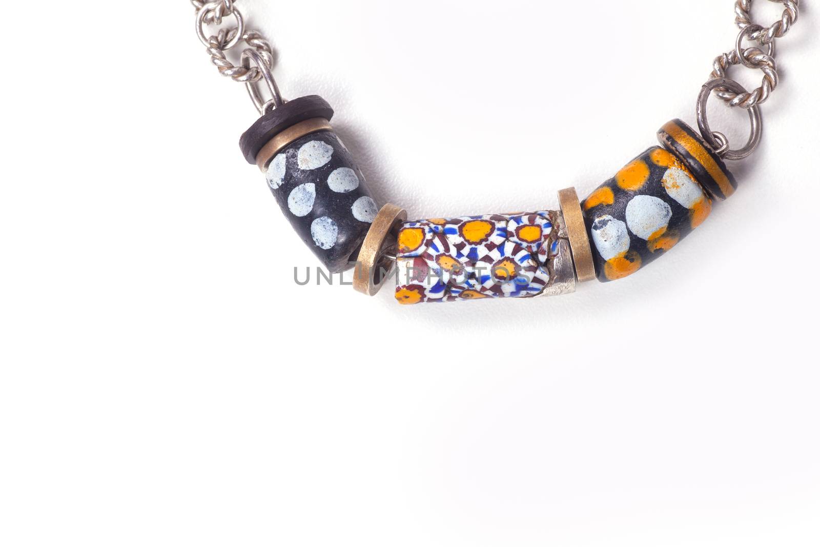 Close up of silver and painted stone necklace isolated on white background, manufactured by Ornella Salamone
