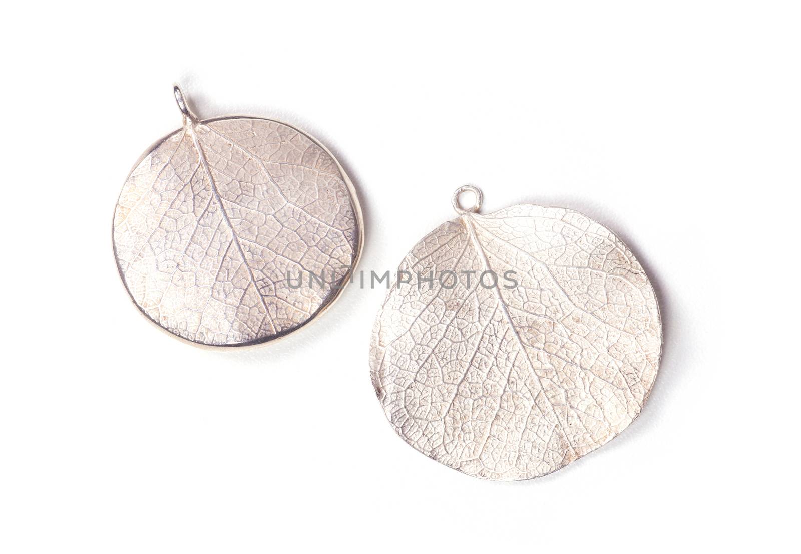 Close up of silver earrings isolated on white background manufactured by Ornella Salamone