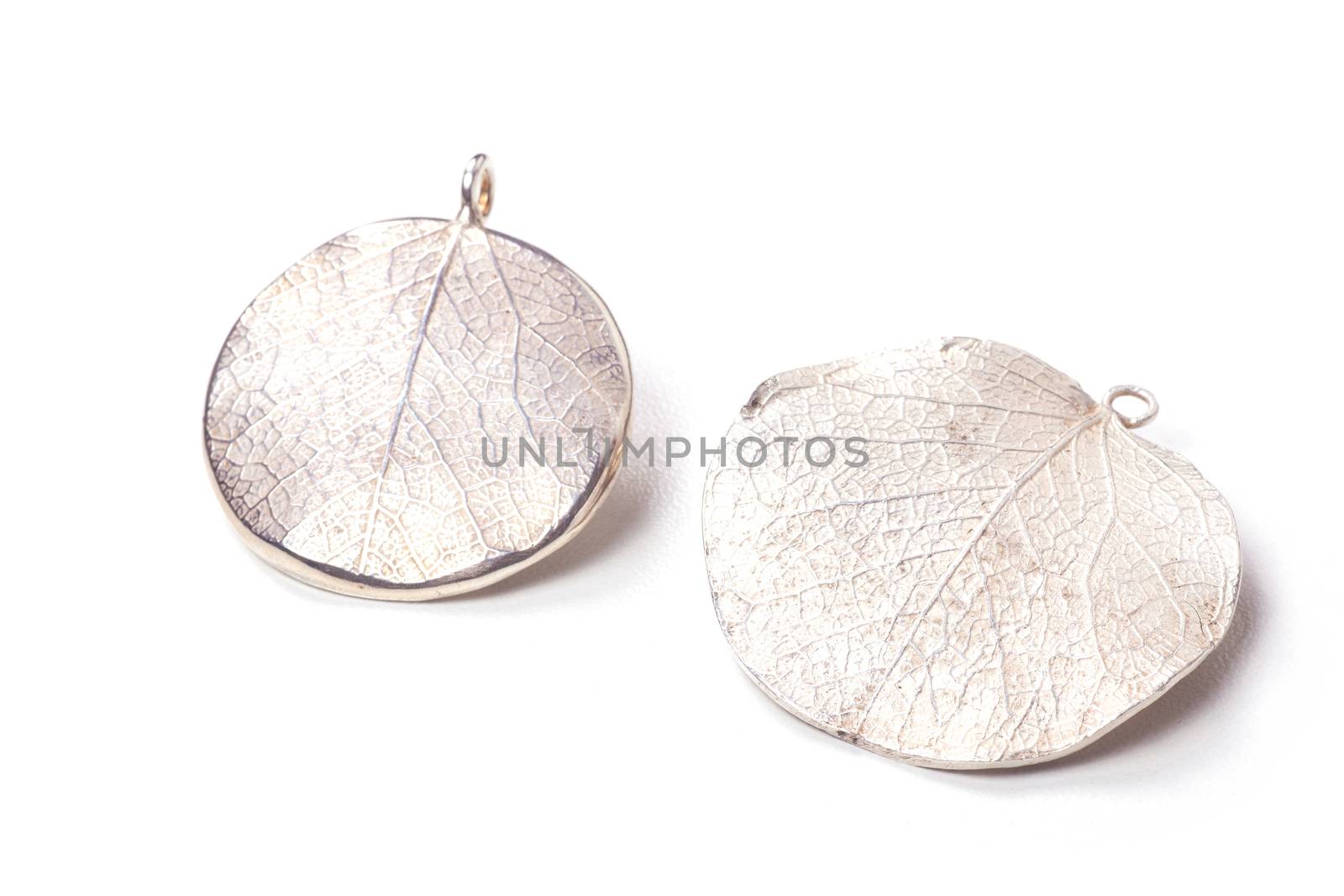 Close up of silver earrings isolated on white background manufactured by Ornella Salamone