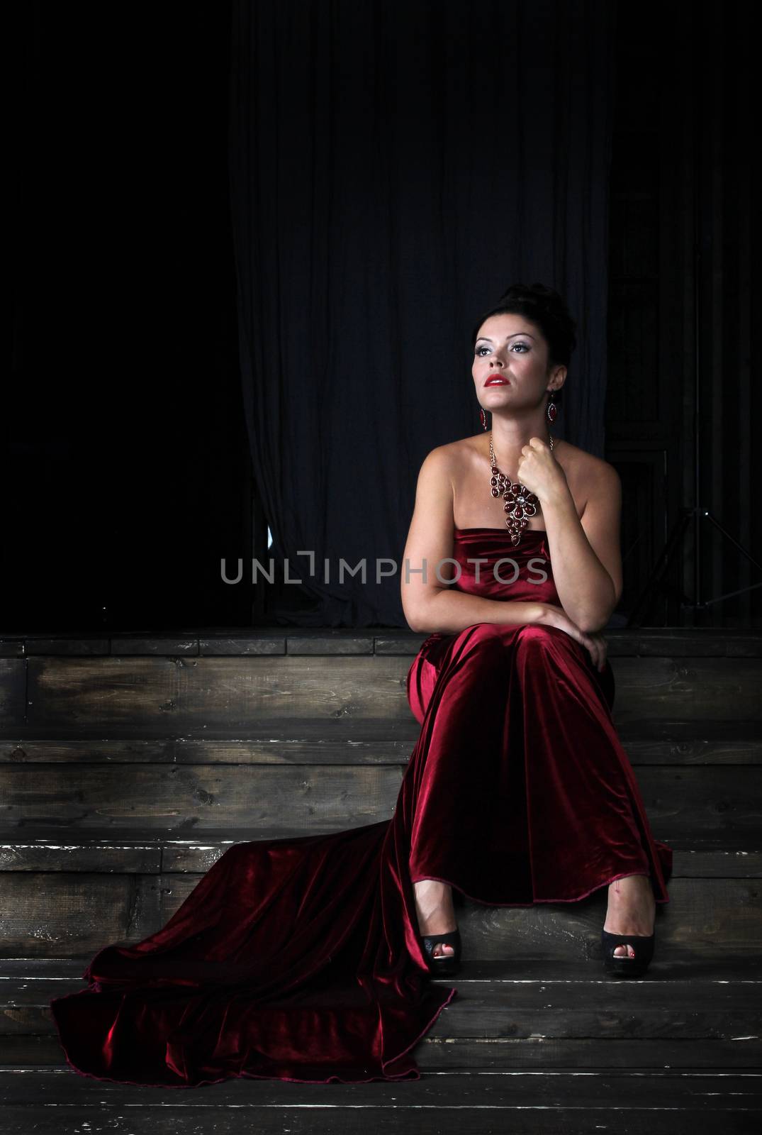 Lady in red sitting on stairs