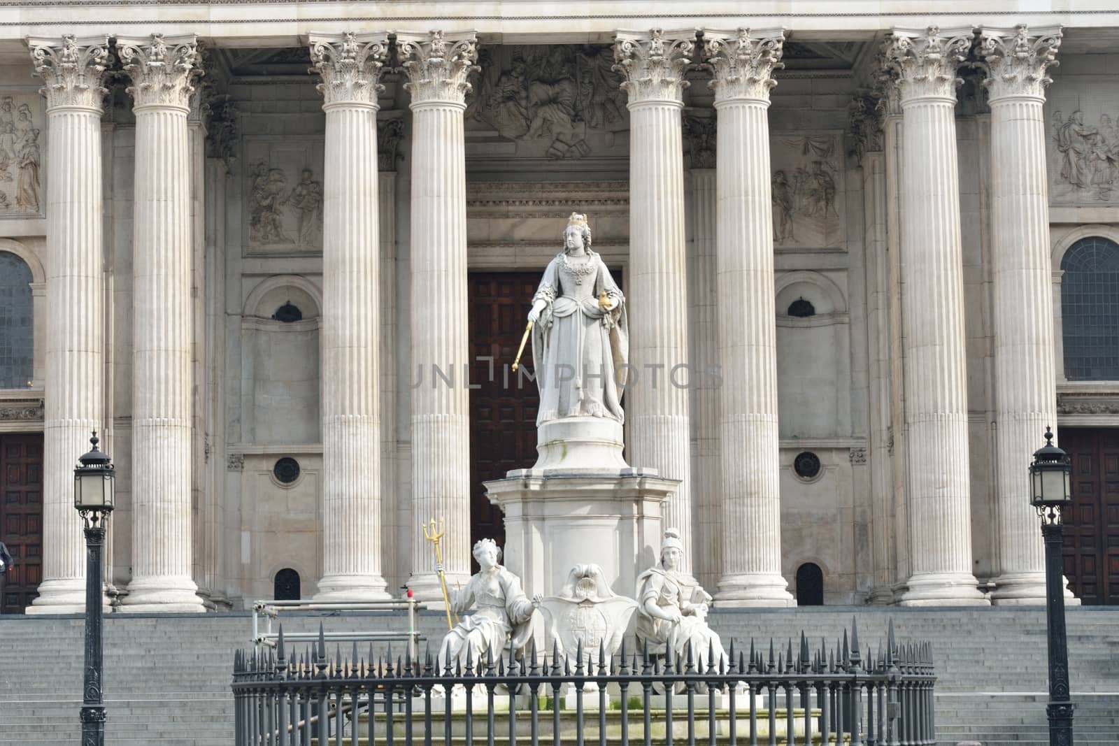 Statue of Queen Victoria in front of St Pauls with columns behind
