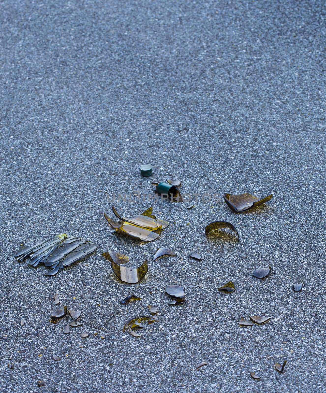 broken bottle on an asphalt floor.