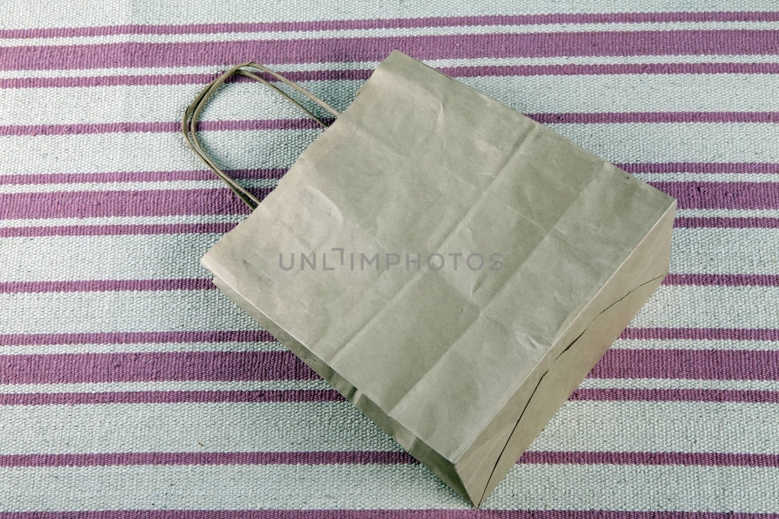 Brown paper shopping bag on a beautiful background.