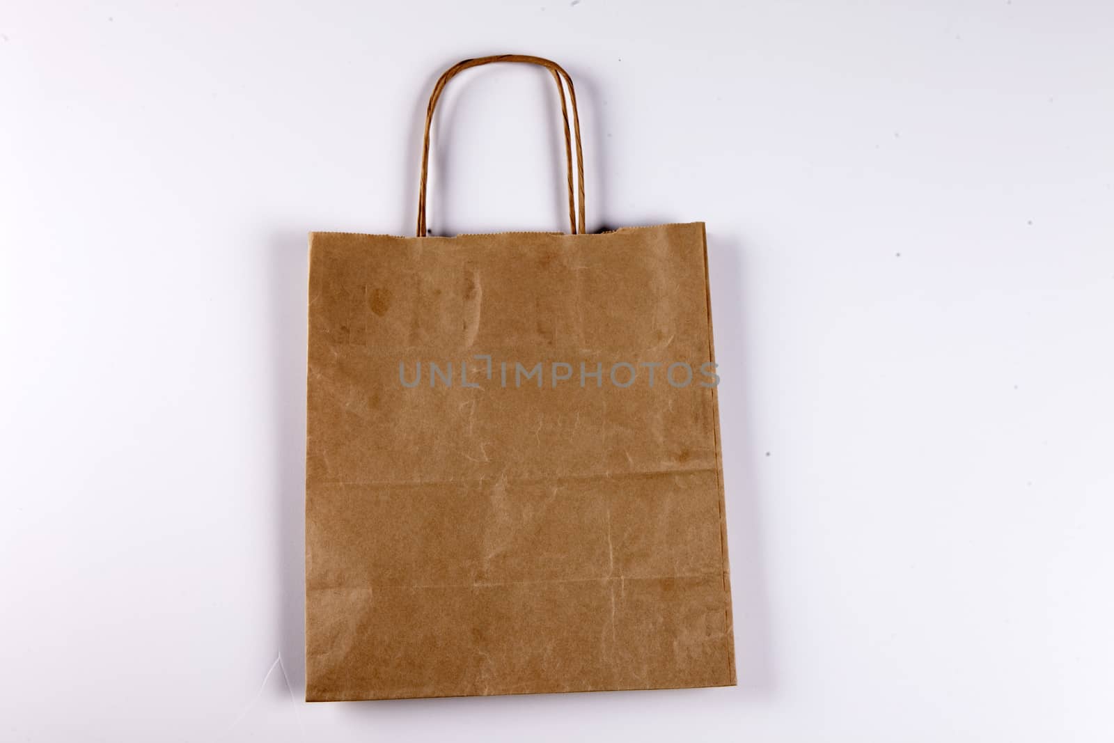 Brown paper shopping bag on a beautiful background by mcherevan