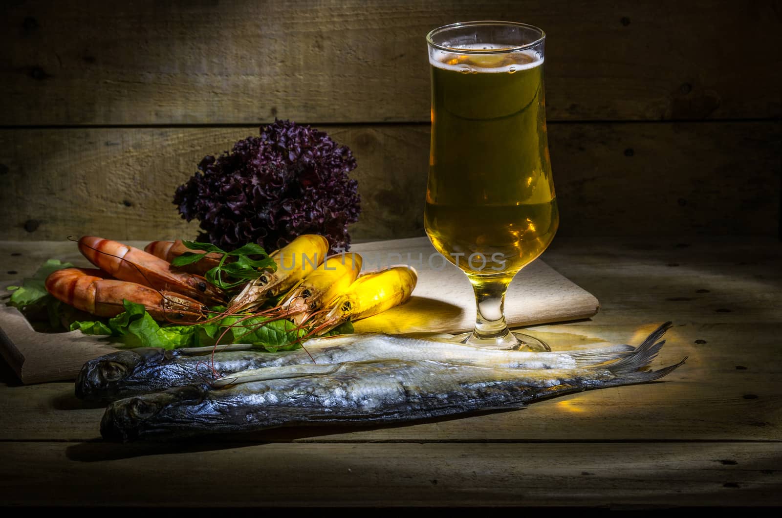 Still life with beer, shrimp, stockfish and fresh herbs