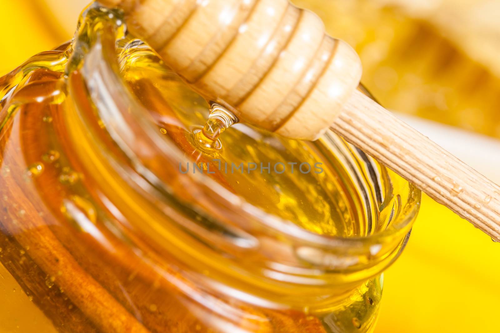 Pot of honey.Honey drip in jar on the table. Close up