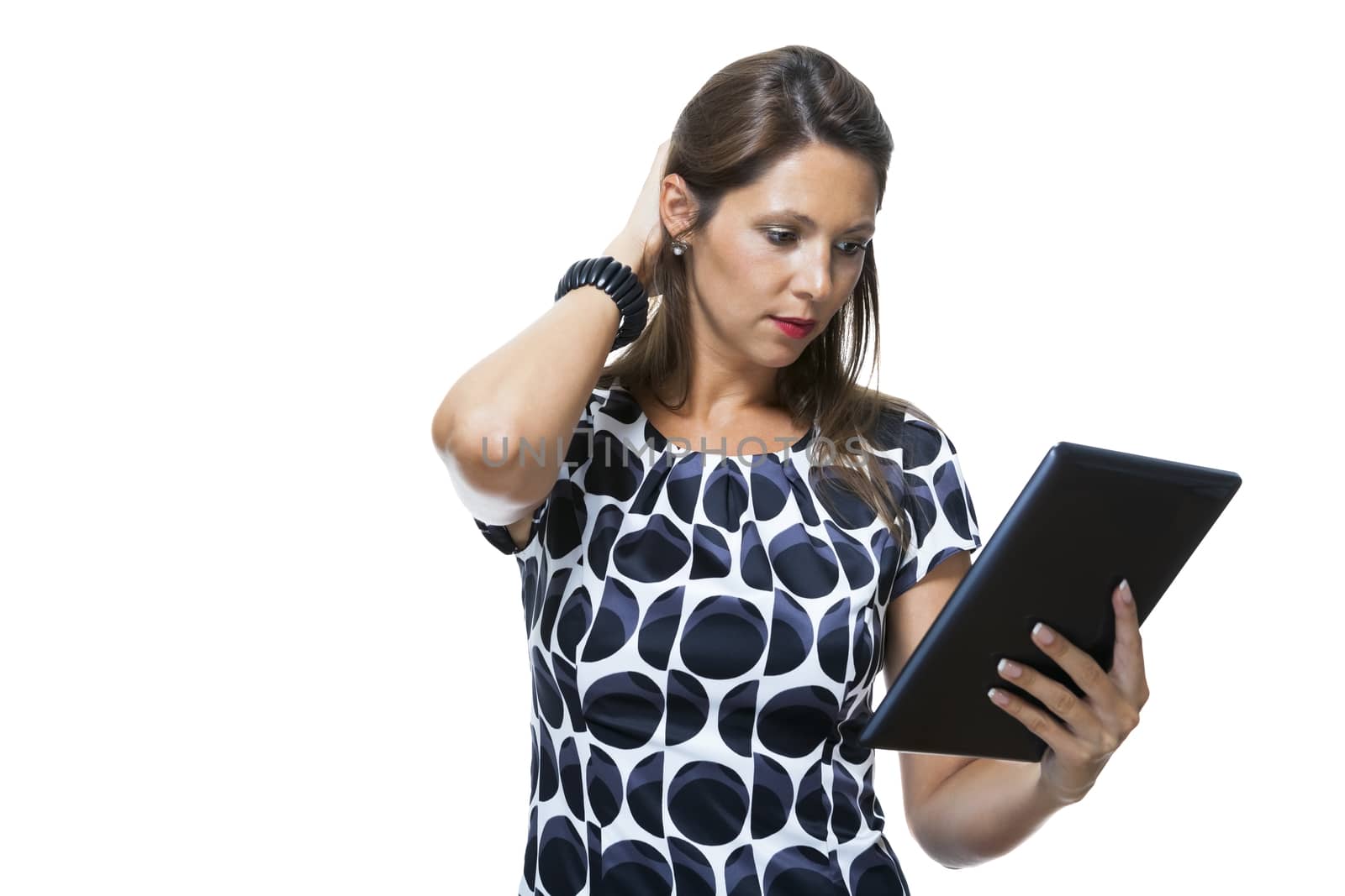 Portrait of a Smiling Lady in an Elegant Printed Dress Holding a Tablet Computer with Copy Space While Looking at the Camera. Isolated on White Background.