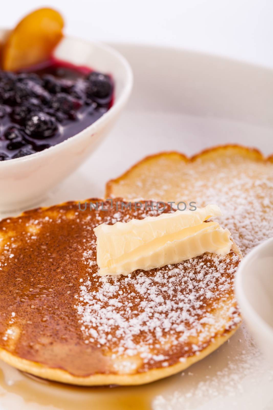 tasty sweet pancakes with vanilla icecream fruit jam and syrup topping