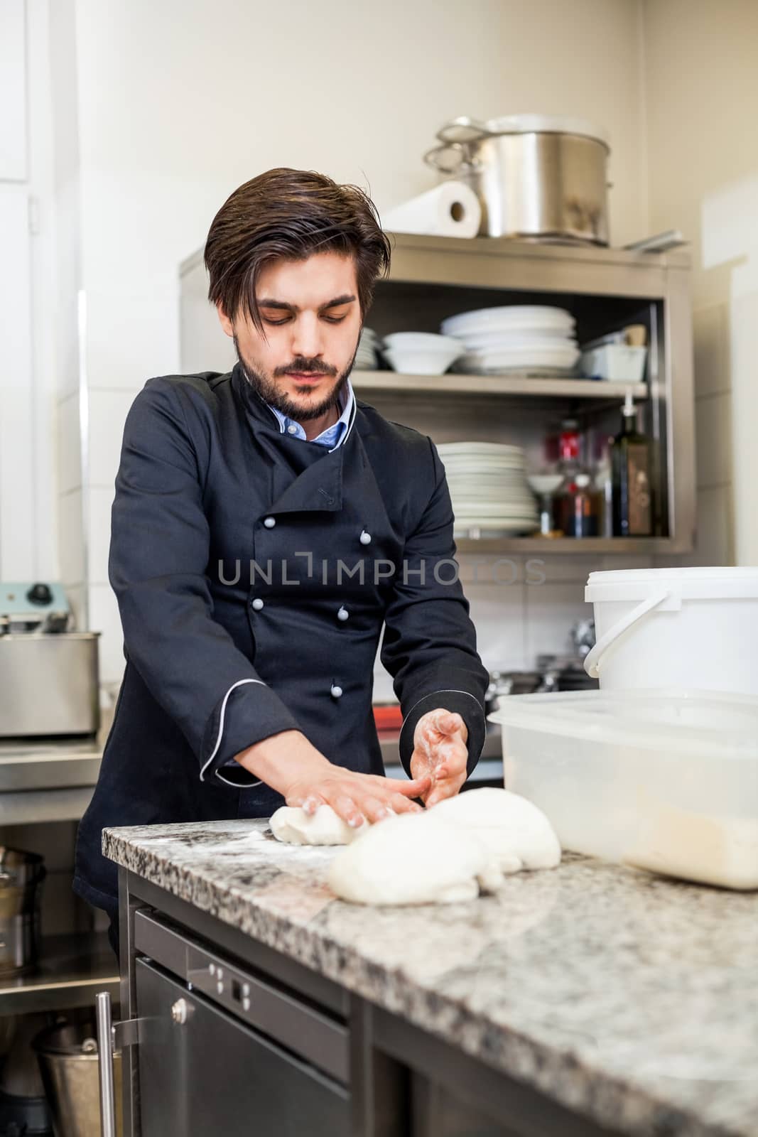 Chef tossing dough while making pastries by juniart