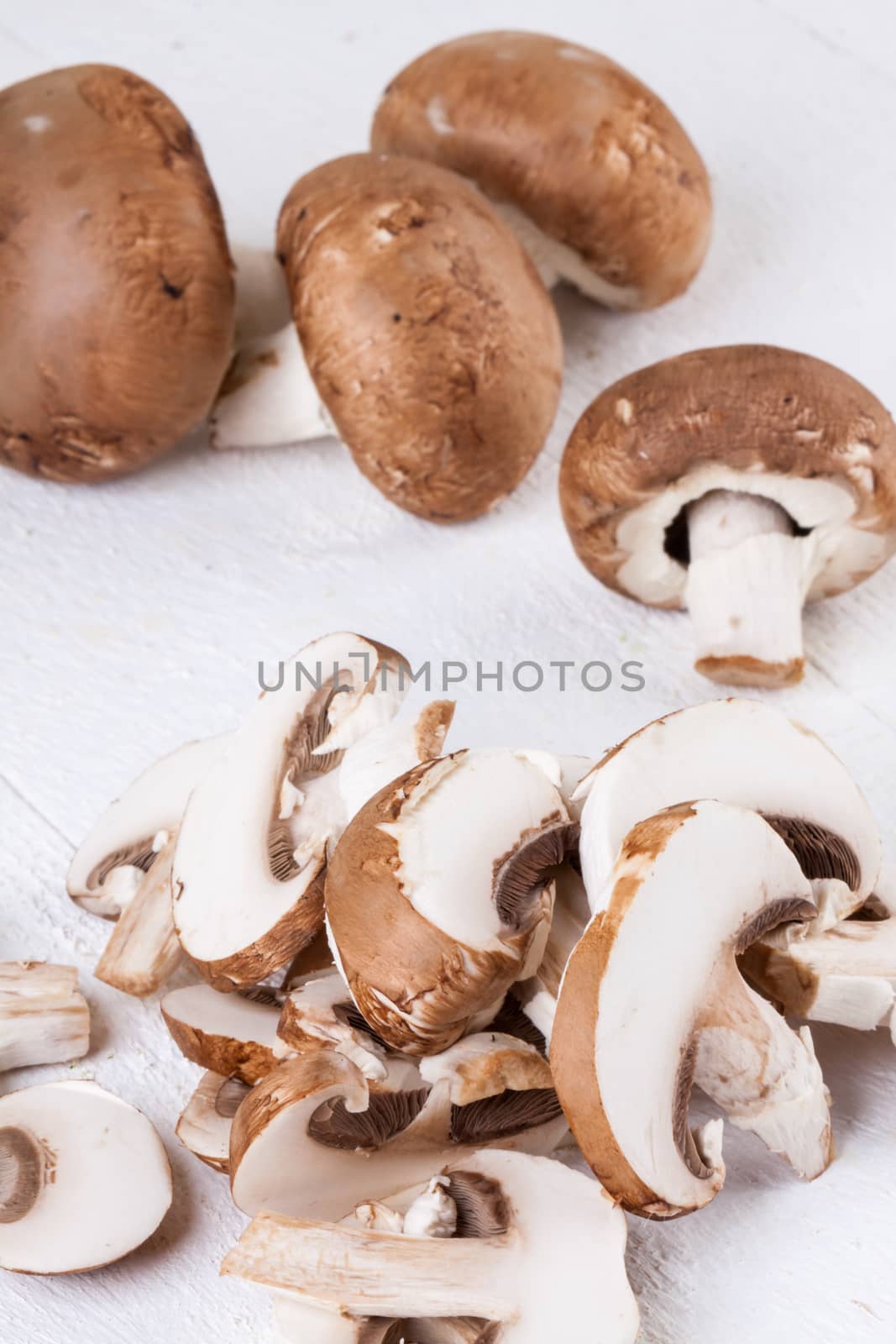 Diced and whole agaricus brown button mushrooms by juniart