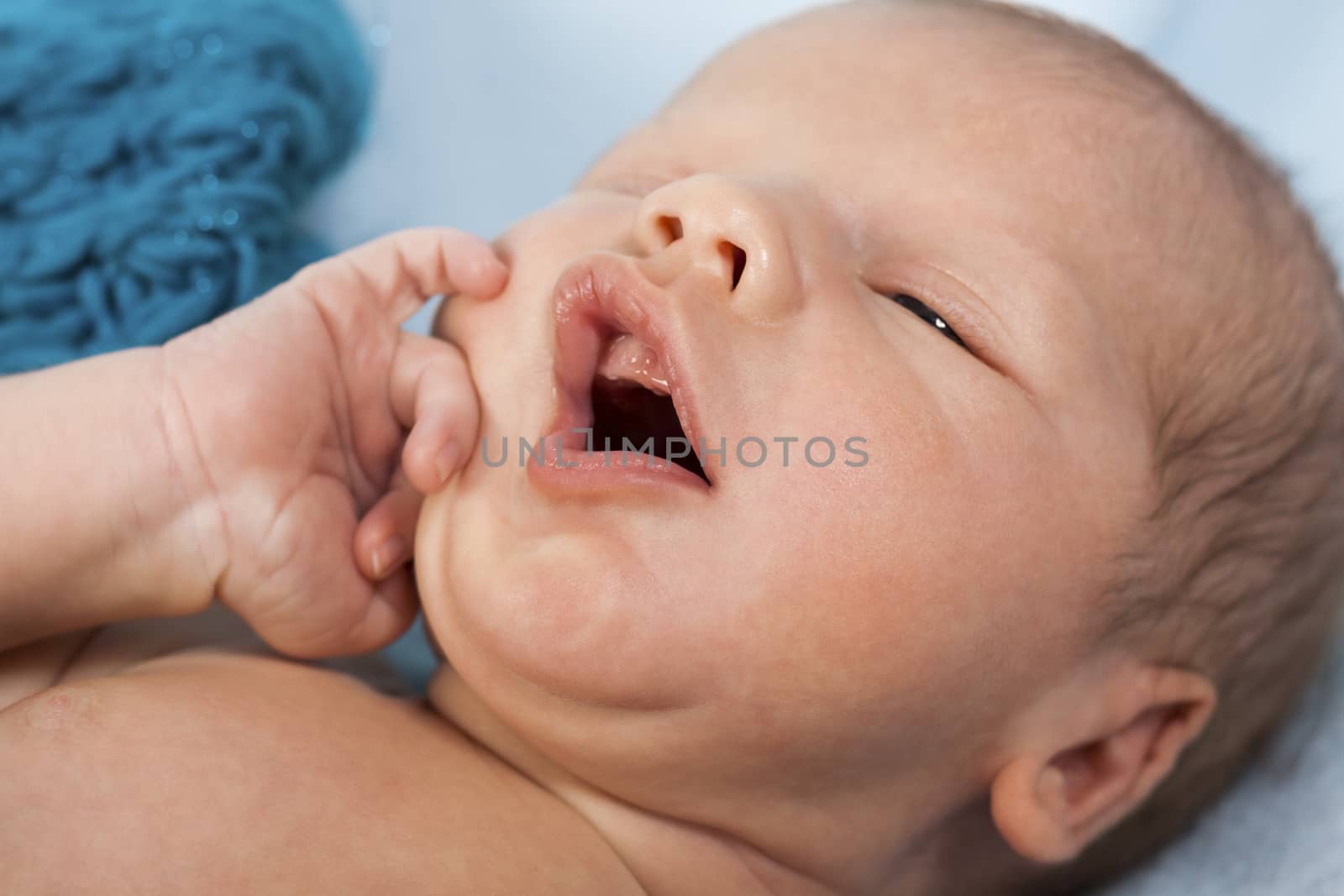 Close up Cute White New Born Baby Lying in Prone on White Cotton Cloth with Open Mouth