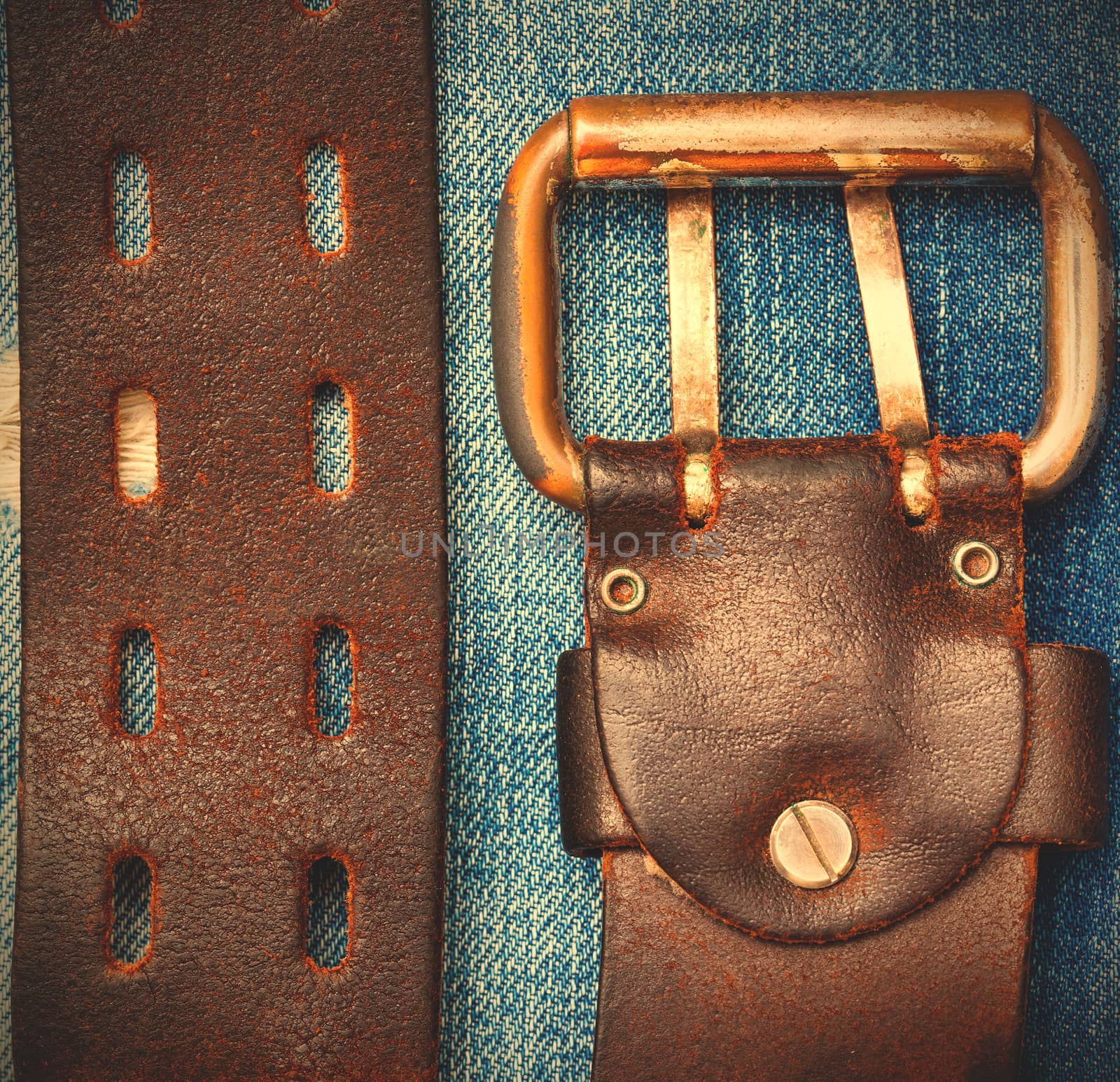 vintage leather belt on a denim background, close up. instagram image style